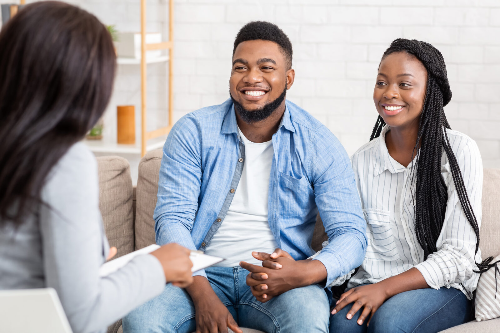 Together Again. Portrait Of Happy African American Couple Holding Hands After Reconciliation On Marital Therapy Session At Psychologist's Office.